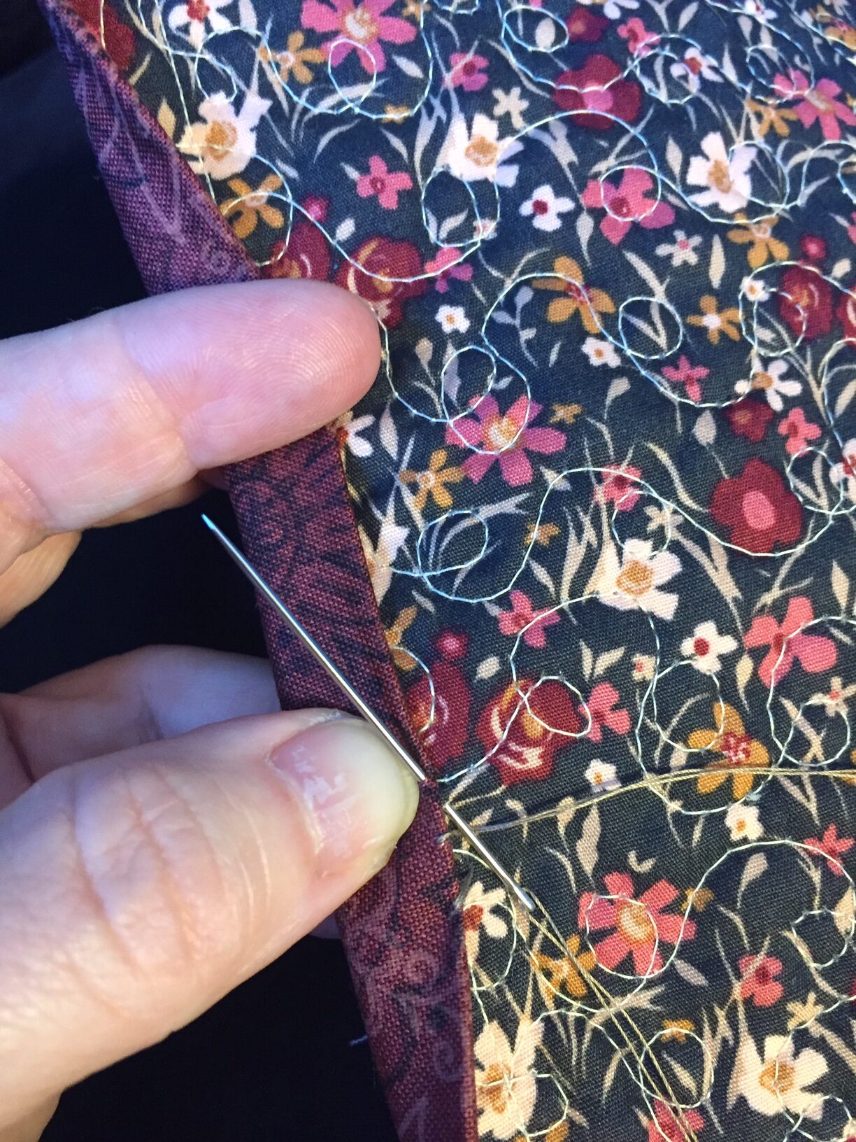 hand sewing the binding