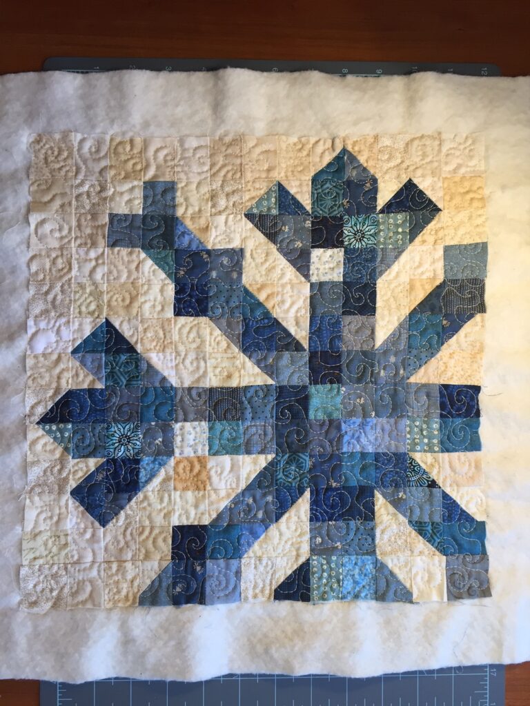 layered and quilted single snowflake quilt