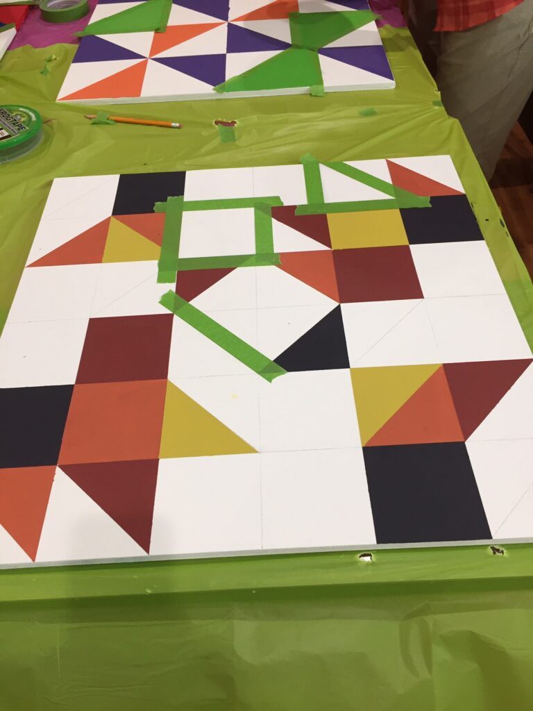 traced, taped and partially painted barn quilt