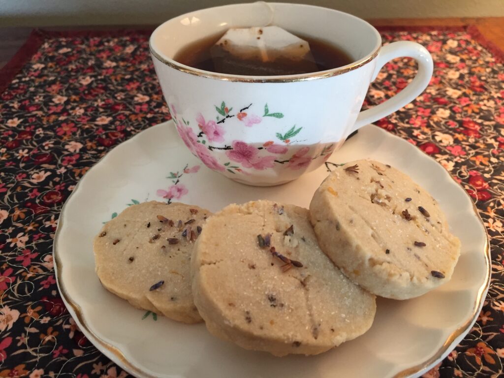three lavender shortbread cookies and a cup of tea