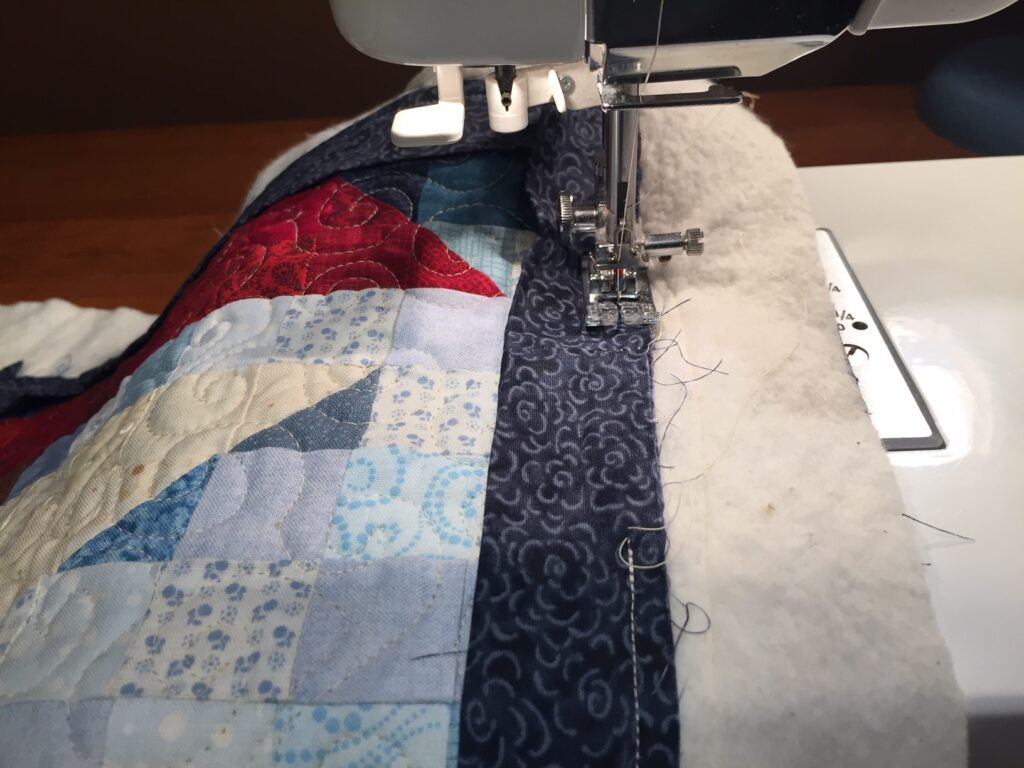 complete sewing binding on quilt