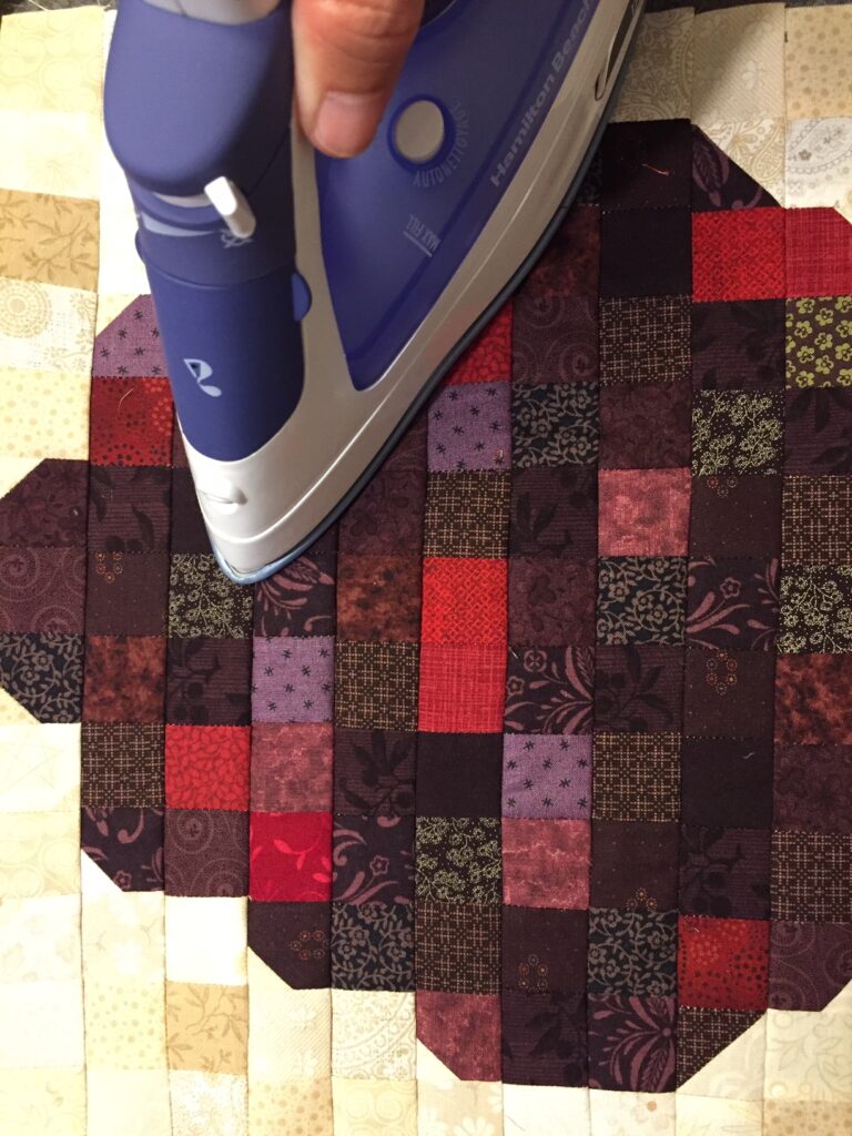 pressing top of quilt with iron
